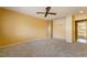 Carpeted bedroom featuring a ceiling fan, neutral walls, and a mirrored closet at 711 Sari Dr, Las Vegas, NV 89110