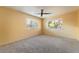 Spacious carpeted bedroom with neutral walls, ceiling fan, and windows providing natural light at 711 Sari Dr, Las Vegas, NV 89110