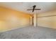 Spacious carpeted bedroom with neutral walls, ceiling fan, and closet at 711 Sari Dr, Las Vegas, NV 89110
