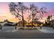 Expansive driveway leads to a charming home with mature trees and decorative accents at 711 Sari Dr, Las Vegas, NV 89110
