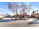 Single-story home with a red tile roof, long driveway, and desert landscaping offers curb appeal at 711 Sari Dr, Las Vegas, NV 89110