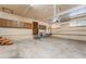 Spacious garage with ample storage cabinets, concrete flooring, and a door leading to the interior at 711 Sari Dr, Las Vegas, NV 89110