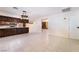 Open-concept kitchen and living area with dark wood cabinetry and tile flooring at 711 Sari Dr, Las Vegas, NV 89110