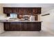 Kitchen with granite countertops, dark wood cabinets and stainless steel appliances at 711 Sari Dr, Las Vegas, NV 89110