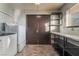 Well-equipped laundry area includes modern washer/dryer, storage shelves, and ample counter space at 711 Sari Dr, Las Vegas, NV 89110