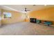 Bright living room with neutral carpet, ceiling fan, and modern storage at 711 Sari Dr, Las Vegas, NV 89110