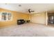 Bright living room with neutral carpet, ceiling fan, and modern storage at 711 Sari Dr, Las Vegas, NV 89110