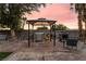 Outdoor kitchen with barbecue, chairs, and overhead shade provides the perfect venue for outdoor dining and entertaining at 711 Sari Dr, Las Vegas, NV 89110