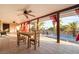 Covered patio with dining set, ceiling fans, and views of the pool area, perfect for entertaining at 711 Sari Dr, Las Vegas, NV 89110