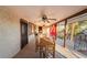 Relaxing covered patio featuring a dining table, ceiling fans, and comfortable seating options at 711 Sari Dr, Las Vegas, NV 89110
