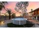 View of backyard above-ground pool, large mature trees, and rear of home under beautiful sunset at 711 Sari Dr, Las Vegas, NV 89110