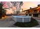 Backyard with an above-ground pool, large mature trees, and rear of home with deck and balcony at 711 Sari Dr, Las Vegas, NV 89110