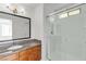 Bathroom featuring a shower with glass doors and a granite-topped wood vanity at 7200 Pirates Cove Rd # 2025, Las Vegas, NV 89145