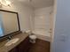 Bathroom featuring granite vanity, bathtub, and wood-look flooring at 7200 Pirates Cove Rd # 2025, Las Vegas, NV 89145