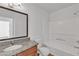 Well-lit bathroom featuring granite counters, wood cabinets, and a shower-tub combo at 7200 Pirates Cove Rd # 2025, Las Vegas, NV 89145