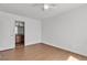 Bedroom featuring wood-look floors and direct access to an attached bathroom at 7200 Pirates Cove Rd # 2025, Las Vegas, NV 89145