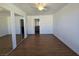 Bedroom features wood-look flooring, ceiling fan, and mirrored closet doors at 7200 Pirates Cove Rd # 2025, Las Vegas, NV 89145