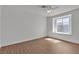 Bright bedroom with wood-look flooring and natural light from a single window at 7200 Pirates Cove Rd # 2025, Las Vegas, NV 89145