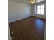 Bedroom with wood-look flooring, ceiling fan, and window with natural light at 7200 Pirates Cove Rd # 2025, Las Vegas, NV 89145