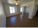 Bedroom features wood-look flooring, mirrored closet doors, and a sunlit window at 7200 Pirates Cove Rd # 2025, Las Vegas, NV 89145