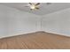 A bright bedroom with wood-look flooring, a ceiling fan, a closet, and a white door at 7200 Pirates Cove Rd # 2025, Las Vegas, NV 89145