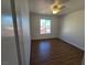 Bedroom with window, wood-look flooring, and ceiling fan at 7200 Pirates Cove Rd # 2025, Las Vegas, NV 89145