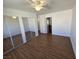 Bright bedroom with ceiling fan, wood-look flooring, and mirrored closet doors at 7200 Pirates Cove Rd # 2025, Las Vegas, NV 89145
