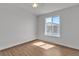 Bright bedroom with wood-look flooring and natural light from a single window at 7200 Pirates Cove Rd # 2025, Las Vegas, NV 89145