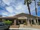 Exterior shot of the clubhouse with stone accents and desert landscaping under a sunny sky at 7200 Pirates Cove Rd # 2025, Las Vegas, NV 89145