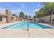 Community pool with lounge chairs and lush trees providing shade at 7200 Pirates Cove Rd # 2025, Las Vegas, NV 89145