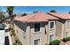 Tan two-story condo with a terra cotta colored roof and desert landscaping on a sunny day at 7200 Pirates Cove Rd # 2025, Las Vegas, NV 89145
