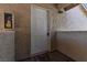 Front door of unit 2025 with a tan stucco wall, a welcome mat and fire extinguisher on the side at 7200 Pirates Cove Rd # 2025, Las Vegas, NV 89145