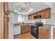 Open kitchen design featuring white appliances, wood cabinets, and granite countertops at 7200 Pirates Cove Rd # 2025, Las Vegas, NV 89145