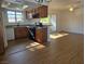 Inviting open-concept kitchen featuring granite counters, black appliances, and bar seating at 7200 Pirates Cove Rd # 2025, Las Vegas, NV 89145