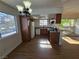 Open-concept kitchen with wood cabinets, granite counters and bar with view to balcony at 7200 Pirates Cove Rd # 2025, Las Vegas, NV 89145