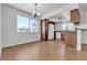 Bright living room with wood-look floors leading to an open kitchen and dining area at 7200 Pirates Cove Rd # 2025, Las Vegas, NV 89145