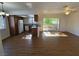 Sun-drenched living room and open-concept kitchen with granite bar and wood cabinets at 7200 Pirates Cove Rd # 2025, Las Vegas, NV 89145