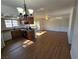 Bright living room with open-concept kitchen including granite counters and black appliances at 7200 Pirates Cove Rd # 2025, Las Vegas, NV 89145