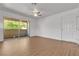 Bright living room boasts wood-look flooring and a glass sliding door to a balcony at 7200 Pirates Cove Rd # 2025, Las Vegas, NV 89145