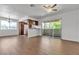 Living room with wood-look flooring, a sliding door to a patio, and a breakfast bar to the kitchen at 7200 Pirates Cove Rd # 2025, Las Vegas, NV 89145