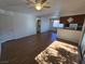 Open-concept living area with wood floors, and white walls with a door to the left at 7200 Pirates Cove Rd # 2025, Las Vegas, NV 89145