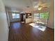 Bright living room with wood floors, ceiling fan, and sliding glass doors to a balcony at 7200 Pirates Cove Rd # 2025, Las Vegas, NV 89145