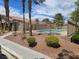 Community pool area surrounded by palm trees and well-kept landscaping on a sunny day at 7200 Pirates Cove Rd # 2025, Las Vegas, NV 89145