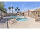 Community pool and spa with tropical palm trees, and ample concrete sundeck seating and lounging areas at 7200 Pirates Cove Rd # 2025, Las Vegas, NV 89145