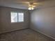 Neutral bedroom featuring plush carpeting, a ceiling fan, and plantation shutters for privacy at 734 Rusty Spur Dr, Henderson, NV 89014