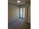 This bedroom has neutral colored walls, gray carpet and French doors at 734 Rusty Spur Dr, Henderson, NV 89014