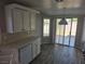 Eat-in kitchen with white cabinetry, modern appliances, and sliding glass doors leading to the backyard at 734 Rusty Spur Dr, Henderson, NV 89014
