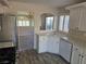 Bright kitchen with white cabinets, stainless steel appliances, and an open view of the living room at 734 Rusty Spur Dr, Henderson, NV 89014