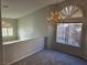Inviting living room showcasing a decorative chandelier and arched windows with plantation shutters at 734 Rusty Spur Dr, Henderson, NV 89014
