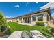 Landscaped backyard featuring artificial turf, lounge chairs, and a patio perfect for outdoor entertaining at 7473 Deschutes Cir, Las Vegas, NV 89129